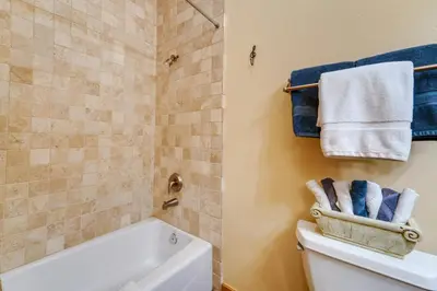 a bathroom with a tub and a toilet and towels at Boulders Truckee Condo Near Donner Lake and Skiing! in Truckee