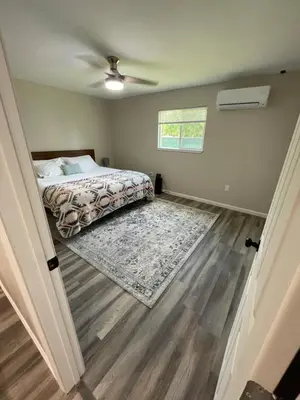 a bedroom with a bed and a ceiling fan at Beautiful spacious guest home in Roseville