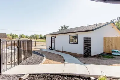 a house with a gate and a fence at Beautiful spacious guest home in Roseville