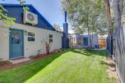 a house with a blue door and a yard at MidTown Reno Vacation Rental with Fenced-In Yard! in Reno