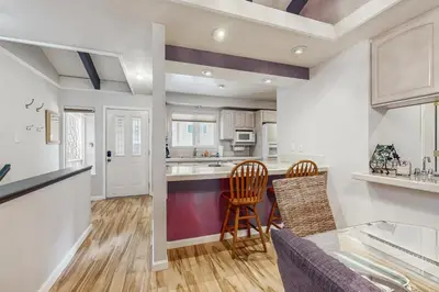a kitchen with a counter and two chairs and a table at Mountain Shadows in Incline Village