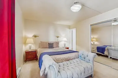 a bedroom with a bed and a couch and a mirror at Mountain Shadows in Incline Village