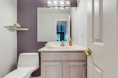 a bathroom with a toilet and a sink and a mirror at Mountain Shadows in Incline Village