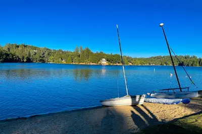 two boats sitting on the shore of a lake at Jordan Oak in Groveland
