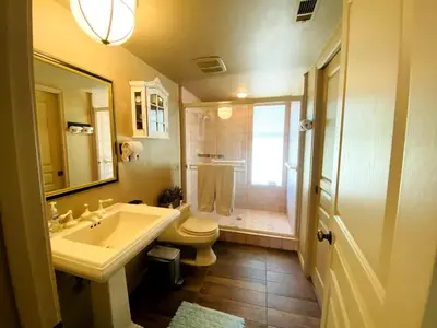 a bathroom with a sink and a toilet and a shower at Sequoia Cabin by the River in Three Rivers