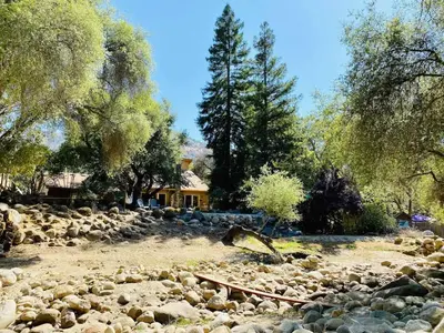 a large pile of rocks in front of a house at Sequoia Cabin by the River in Three Rivers