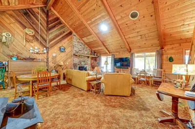 a living room with wooden ceilings and a dining room at Countryside Views Family-Friendly Badger Cabin in Badger