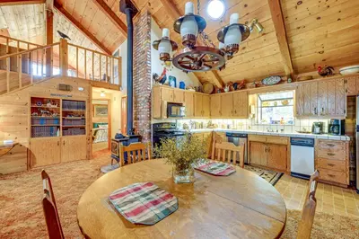 a large kitchen with a wooden table in a room at Countryside Views Family-Friendly Badger Cabin in Badger