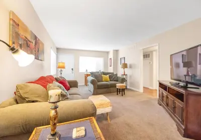 a living room with a couch and a tv at Longer Stays for Travelers- Apt Blocks from Hospital, Downtown in Visalia