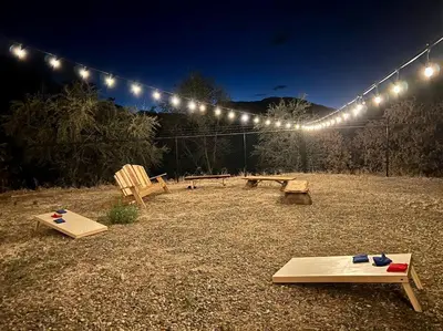 a backyard with a picnic table and a string of lights at Scenic Spanish Rancho - Breathtaking Views in Three Rivers