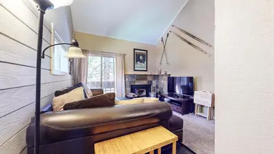 a living room with a leather couch and a fireplace at La Residence V #T05 condo in Mammoth Lakes