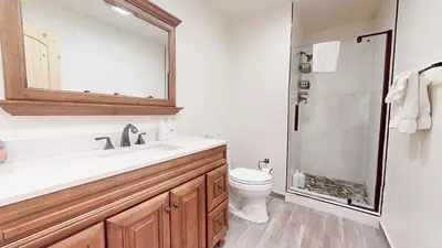 a bathroom with a sink and a toilet and a mirror at Chamonix #64 condo in Mammoth Lakes