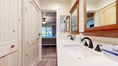 a bathroom with two sinks and wooden cabinets at Chamonix #64 condo in Mammoth Lakes