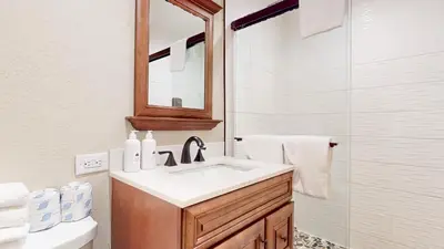 a bathroom with a sink and a mirror and a toilet at Chamonix #64 condo in Mammoth Lakes
