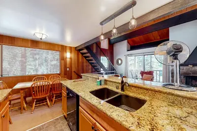 a kitchen with a sink and a table with chairs at Serene Escape in Kings Beach