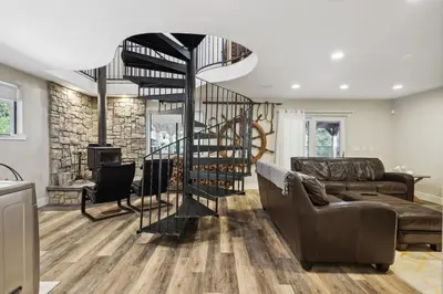 a living room with a couch and a fireplace at Spacious Pine Mountain Lake Cabin Rental with Decks in Groveland