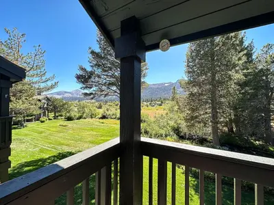 a view from the porch of a cabin with a view of the mountains at Snowcreek III #452 condo in Mammoth Lakes