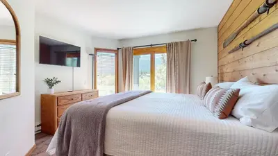a bedroom with a large bed and a window at Snowcreek III #452 condo in Mammoth Lakes