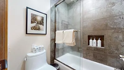 a bathroom with a shower and a toilet and a glass shower stall at Snowcreek III #452 condo in Mammoth Lakes