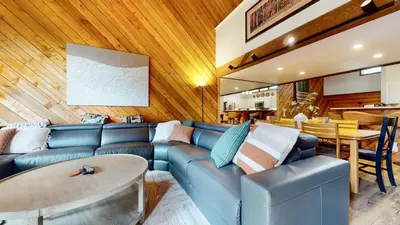 a living room with a blue couch and a table at Snowcreek III #452 condo in Mammoth Lakes
