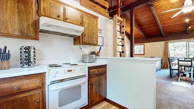 a kitchen with white appliances and wooden cabinets at Lakeview Lodge #2 condo in Mammoth Lakes