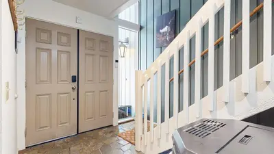 a hallway with a white door and a staircase at Lakeview Lodge #1 condo in Mammoth Lakes
