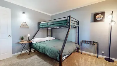 a bedroom with a bunk bed and a table at Lakeview Lodge #1 condo in Mammoth Lakes