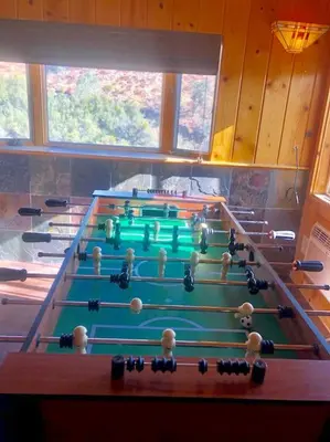 a row of pool tables in a room at Tillie Creek Retreat: a Creekside Oasis in Wofford Heights