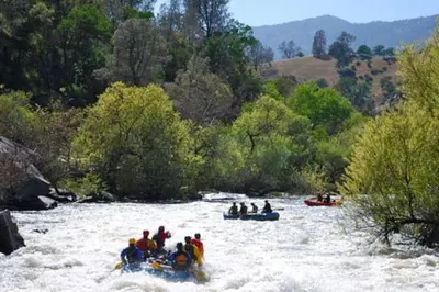 a group of people rafting down a river at Shirley Creek Retreat: a Mountain Oasis in Wofford Heights
