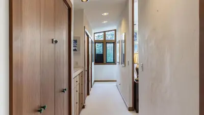 a hallway of a house with wooden doors at Mt. Jola by AvantStay A 5-minute walk away to Palisades and lifts. in Olympic Valley