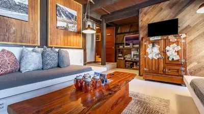 a living room with a couch and a table at Mt. Jola by AvantStay A 5-minute walk away to Palisades and lifts. in Olympic Valley