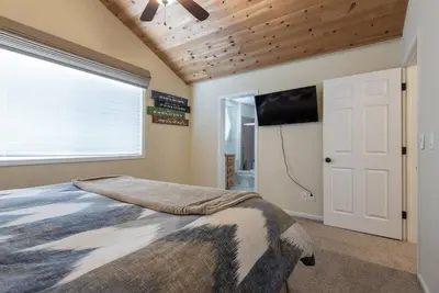a bedroom with a bed and a flat screen tv at Tahoe Vista Home w/ Spa close to Northstar & Lake in Tahoe Vista