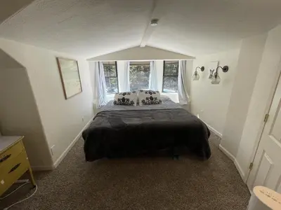 a bedroom with a large bed with a window at Walking Distance To The Lake And Beach! in Kings Beach