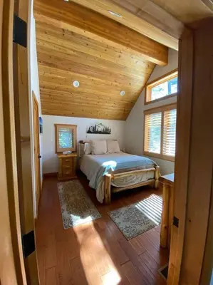 a bedroom with a bed and a wooden ceiling at FamilyfunCabin in Tahoma