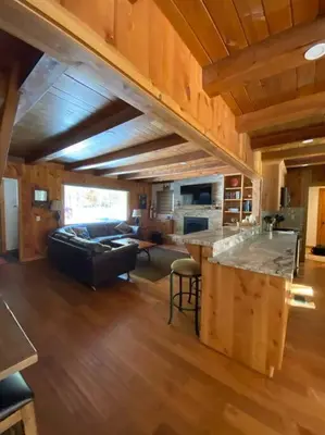 a kitchen and living room with a couch and a counter at FamilyfunCabin in Tahoma
