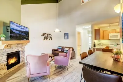 a living room with a fireplace and a dining room at Tahoe Snowbird Retreat in Stateline