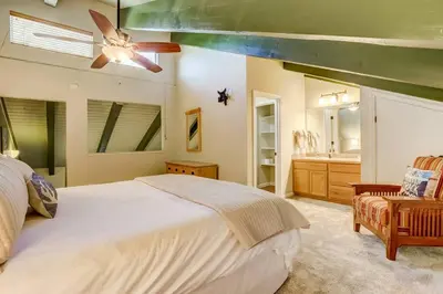 a bedroom with a bed and a ceiling fan at Tahoe Snowbird Retreat in Stateline