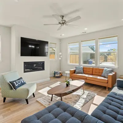 a living room with a couch and a fireplace at Newly Built Murphys Modern Retreat in Murphys