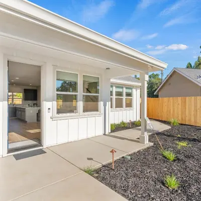a home with whiteiding and a patio at Newly Built Murphys Modern Retreat in Murphys
