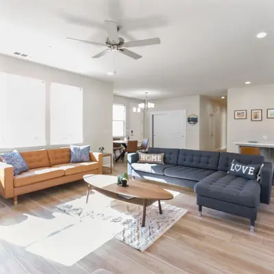 a living room with two couches and a table at Newly Built Murphys Modern Retreat in Murphys