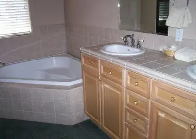 a bathroom with a tub and a sink and a bath tub at Rr-hideaway_down_canyon110 in June Lake