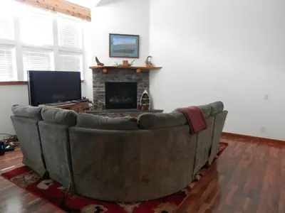 a couch in a living room with a fireplace at Rr-hideaway_down_canyon110 in June Lake