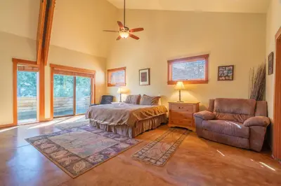 a bedroom with a bed and a chair and a ceiling fan at Rr-carson_view1 Strap18-005 in June Lake