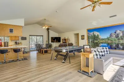a living room with a pool table and a kitchen at Private Lake, Hot Tub and EV Charger Mariposa Home! in Mariposa