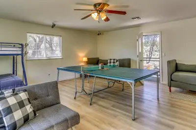 a ping pong table in a living room with a couch at Private Lake, Hot Tub and EV Charger Mariposa Home! in Mariposa