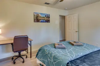 a bedroom with a desk and a bed and a chair at Private Lake, Hot Tub and EV Charger Mariposa Home! in Mariposa