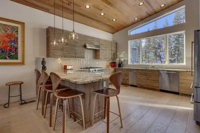 a kitchen with a large wooden table and chairs at Palisades Tahoe Mountain Oasis in Olympic Valley