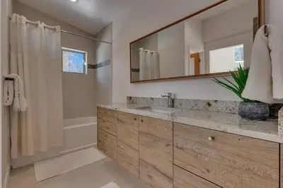 a bathroom with a sink and a mirror at Palisades Tahoe Mountain Oasis in Olympic Valley