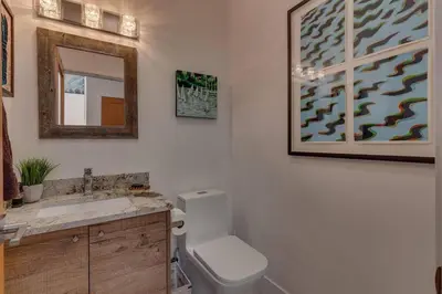 a bathroom with a toilet and a sink and a mirror at Palisades Tahoe Mountain Oasis in Olympic Valley