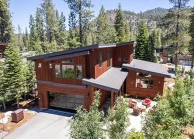 a large wooden house in the middle of a forest at Palisades Tahoe Mountain Oasis in Olympic Valley